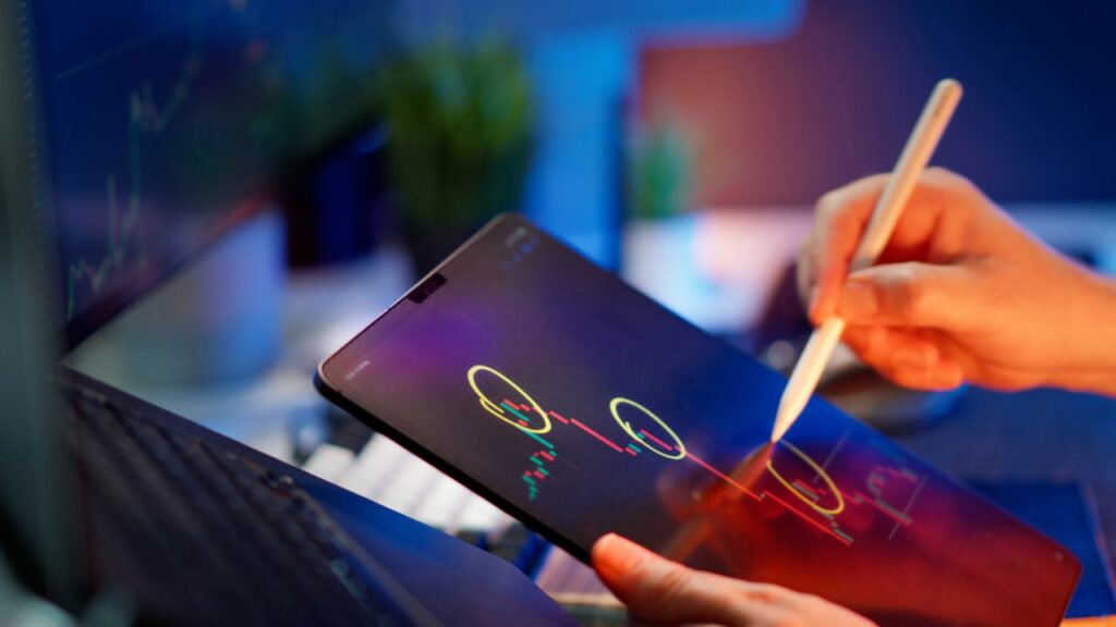 Person analyzing cryptocurrency trends on a tablet with digital pen.