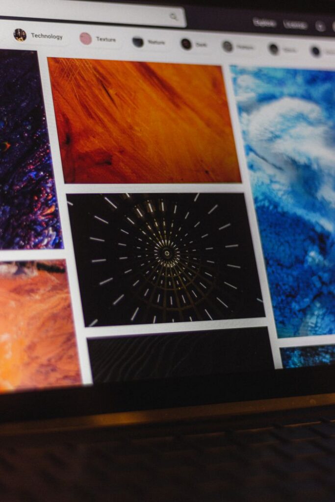 Portable computer with website representing assorted abstract photos under favorites and browser search engine with magnifier symbol